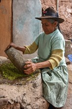 Local woman mortaring herbs