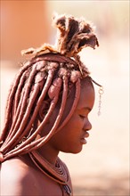 Young Himba with traditional jewelry for married women