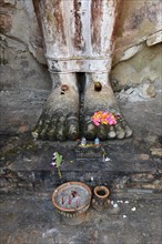 Feet of the standing Buddha statue Phra Attharot