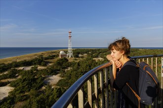 Young woman looking out from the Leuchtturm Darsser Ort lighthouse