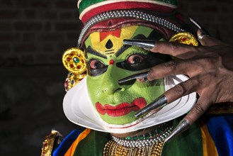 A Katakali artist with the complete make up of the character Krishna for the Santhana Gopalam play during a temple festival