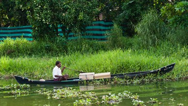 Indian man steering a boat
