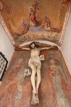 Crucifix and fresco in a chapel