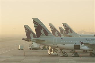 Qatar airways planes at Doha airport shortly after sunrise