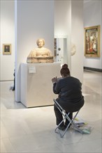 Woman sketching at the Victoria and Albert Museum