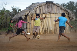 Youngers of the indigenous Xavante people playing football