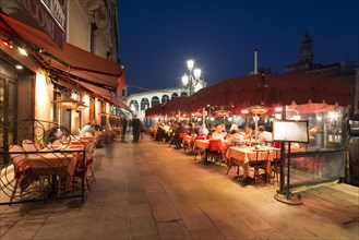 Outdoor restaurant in front of the Rialto Bridge