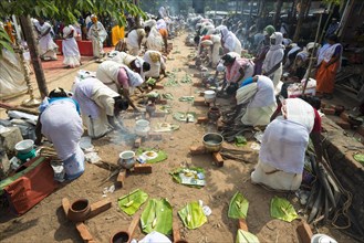 Women cooking Prasad in the busy streets during the Pongala festival
