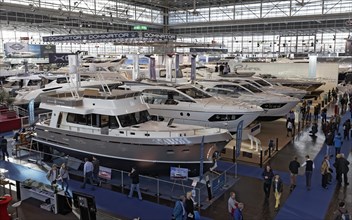 Luxury motor yachts on display in an exhibition hall