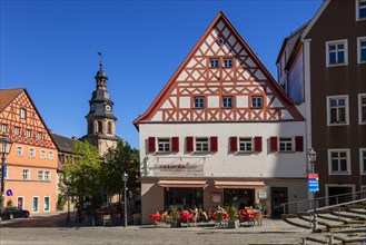 Half-timbered house with tower of the hospital church