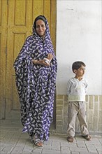 Woman in modern chador with son