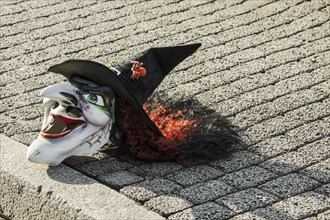 Mask lying in the street during a carnival parade