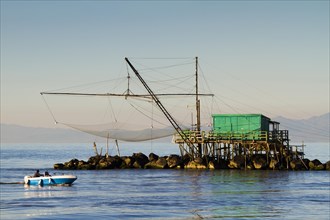 Fisherman's house with a net over the sea in Marina di Pisa
