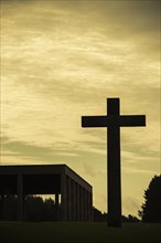 Silhouette of big Christian cross and Chapel of the Holy Cross