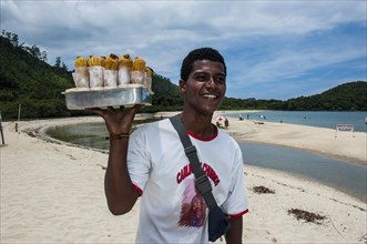 Man selling fruit juice on a beach north of Paraty