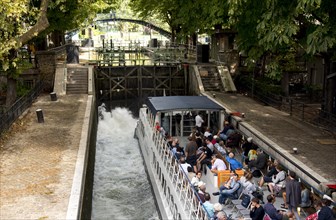 Tourist boat in lock in Canal Saint-Martin