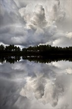 Naveretjarn Lake with dramatic clouds and mirroring