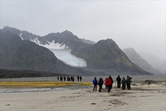 Tourists hiking at Magdalene Fjord