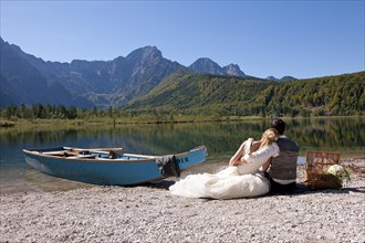 Wedding couple with a boat at Almsee Lake