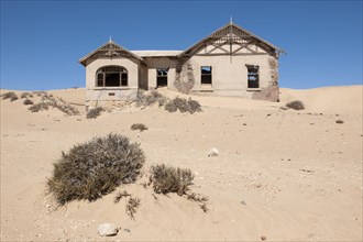 House of a former diamond miners settlement that is slowly covered by the sand of the Namib Desert
