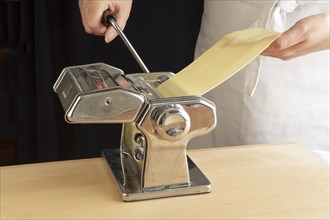 Pasta sheets being rolled with a machine