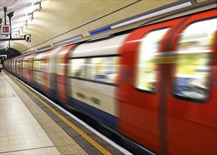 London underground train leaving Charing Cross station