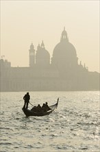 Gondolier on the Grand Canal in front of the Church of Santa Maria della Salute