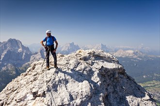 Mountain climber ascending Cristallo di Mezzo along the Via Ferrata Marino Bianchi climbing route on Monte Cristallo above Cortina d'Ampezzo