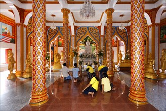 Visitors praying in front of the altar