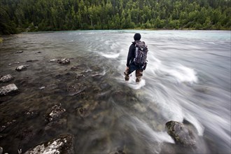 Man wearing fishing boots on the bank of Lowe River near Valdez