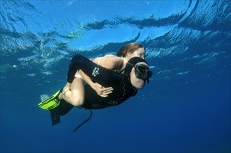 Freediver giving woman a piggyback