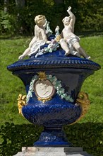 Ornamental vessel with putti made of glazed ceramic