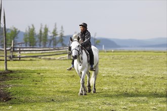 Boy riding a Mongolian horse