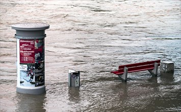 Advertising column and a bench in the flood waters of the Danube River