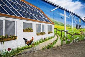 Wall of a house painted with a renewable energy theme