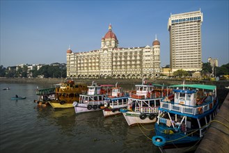 Ferryboats anchoring in the harbour in front of Taj Mahal Palace Hotel