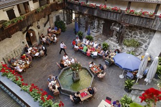 Courtyard of Schattenburg Castle with a restaurant