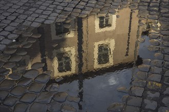 Building reflected in a puddle