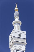 Minaret with a golden crescent moon