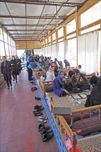 Young Iranians having lunch in a traditional restaurant
