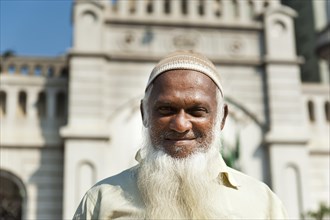 Devout Muslim with cap and long white beard