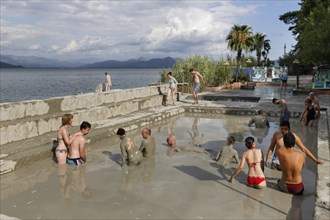 People taking a mud bath