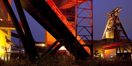 Illuminated gangway to the Ruhr Museum at the Zeche Zollverein Coal Mine Shaft XII with the headframe