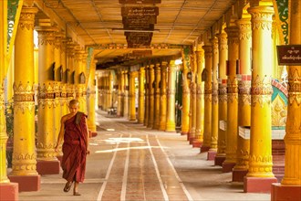Buddhist student monk walking through portico