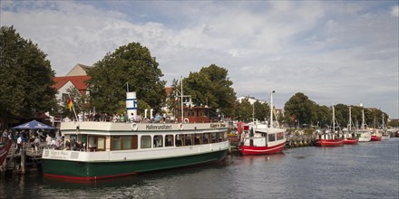 Ship for harbour cruises and fishing boats in the harbour