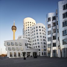 Rheinturm or Rhine Tower with two of the Gehry buildings at Neuer Zollhof