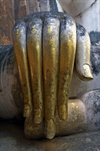 Gilded hand of the Buddha statue Phra Achana