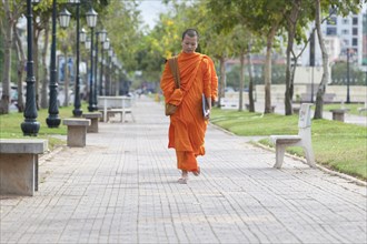 Buddhist monk walking in central Phnom Penh