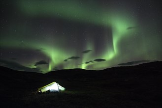Northern lights or aurora borealis over a tent