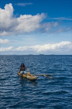 Fishing woman in an outrigger boat